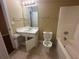 Small bathroom with a toilet and bathtub at 295 Rock House Rd, Lawrenceville, GA 30045