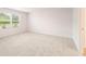 Spacious carpeted bedroom with large window and neutral walls at 8645 Paradise Drive (Lot 76), Douglasville, GA 30134