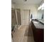 Modern bathroom with glass shower, granite countertop, and tile floor at 44 Peachtree Ne Pl # 424, Atlanta, GA 30309