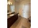 Bathroom with dark wood vanity, granite countertop, and tiled floor at 44 Peachtree Ne Pl # 424, Atlanta, GA 30309