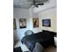 Cozy bedroom with a black comforter, ceiling fan, and artwork on the walls at 44 Peachtree Ne Pl # 424, Atlanta, GA 30309