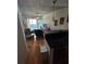 Living room with hardwood floors, balcony access, and view of kitchen and dining area at 44 Peachtree Ne Pl # 424, Atlanta, GA 30309