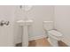 Clean powder room with pedestal sink and toilet at 8647 Paradise Dr, Douglasville, GA 30134