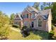 Brick two-story house with a gray roof and landscaping at 2600 Wells Sw Ter, Atlanta, GA 30331