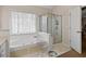 Clean bathroom, featuring a shower and tub combo at 2600 Wells Sw Ter, Atlanta, GA 30331