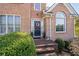 Brick front entrance with a black door and lush greenery at 2600 Wells Sw Ter, Atlanta, GA 30331