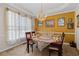 Formal dining room with hardwood floors, chandelier and yellow accent wall at 2600 Wells Sw Ter, Atlanta, GA 30331