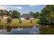 House with a backyard that overlooks a lake at 153 Lakeshore Ct, Mcdonough, GA 30252