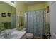 Clean bathroom with a shower/tub combo and green walls at 153 Lakeshore Ct, Mcdonough, GA 30252