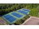 Aerial view of four lighted tennis courts in a community at 316 Willow Cv, Canton, GA 30114