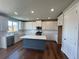 Modern kitchen featuring white cabinets, an island, and hardwood floors at 316 Willow Cv, Canton, GA 30114