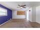 Spacious bedroom with a purple accent wall and ceiling fan at 3689 Laurie Woods Ln, Decatur, GA 30034