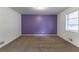 Bedroom with purple accent wall and neutral carpet at 3689 Laurie Woods Ln, Decatur, GA 30034