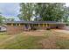 Brick ranch house with yellow shutters and a spacious yard at 3689 Laurie Woods Ln, Decatur, GA 30034