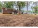 Brick house with a spacious backyard, partially wooded, and a stone pathway at 3689 Laurie Woods Ln, Decatur, GA 30034