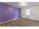 Bedroom with purple accent wall and neutral carpet at 3689 Laurie Woods Ln, Decatur, GA 30034