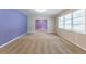Spacious living room with neutral carpet and purple accent wall at 3689 Laurie Woods Ln, Decatur, GA 30034