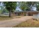Brick ranch house with yellow shutters, driveway and carport at 3689 Laurie Woods Ln, Decatur, GA 30034