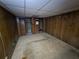 Unfinished basement with wood paneling and carpeted floor at 6039 Pineside Dr, Atlanta, GA 30349