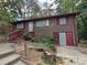 Brick ranch home with a red door and attached garage at 6039 Pineside Dr, Atlanta, GA 30349