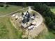 A unique home under construction is shown in an aerial view, highlighting its size and lot at 1197 Dee Kennedy Rd, Auburn, GA 30011