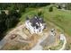 An aerial view showcasing a large new construction home on a spacious lot, with surrounding landscape visible at 1197 Dee Kennedy Rd, Auburn, GA 30011