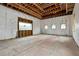 Unfinished basement room with large window and exposed framing at 1197 Dee Kennedy Rd, Auburn, GA 30011