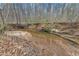 Serene creek with sandy banks and tree-lined borders at 1197 Dee Kennedy Rd, Auburn, GA 30011