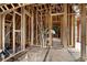Unfinished upstairs hallway with framing and exposed beams at 1197 Dee Kennedy Rd, Auburn, GA 30011