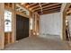 View of the front entrance, showing the dark double doors in the framework of a new home at 1197 Dee Kennedy Rd, Auburn, GA 30011