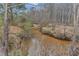 Picturesque creek meandering through lush woods at 1197 Dee Kennedy Rd, Auburn, GA 30011