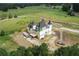 Castle-style home under construction, situated on a spacious lot with mature trees at 1197 Dee Kennedy Rd, Auburn, GA 30011