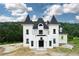 A unique castle-style home with a black roof at 1197 Dee Kennedy Rd, Auburn, GA 30011