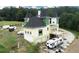 A unique home under construction is shown in this aerial view, showcasing its turrets and large lot at 1197 Dee Kennedy Rd, Auburn, GA 30011