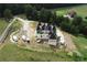 Aerial view of a new custom home under construction, showcasing its unique architectural design and expansive lot at 1197 Dee Kennedy Rd, Auburn, GA 30011