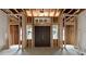 Interior view of the front entrance during new home construction, showcasing the double doors and framing at 1197 Dee Kennedy Rd, Auburn, GA 30011