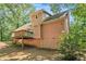 Back of house with wooden deck and surrounding trees at 2606 Clifton Downs Se Trl, Atlanta, GA 30316