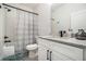 Modern bathroom with white cabinets, granite countertop, and a shower/tub combo at 396 Academy St, Alpharetta, GA 30009