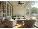 Comfortable screened porch features wicker furniture and a ceiling fan at 261 Cherokee Ne St, Marietta, GA 30060