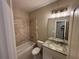 Bathroom with tiled shower, vanity, and modern fixtures at 5544 Whispering Swan Ct, Douglasville, GA 30135
