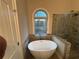 Elegant bathroom with freestanding tub, glass shower, and stylish tilework at 5544 Whispering Swan Ct, Douglasville, GA 30135