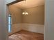 Dining room with wainscoting, hardwood floors, and a chandelier at 5544 Whispering Swan Ct, Douglasville, GA 30135