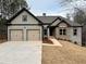 Charming two-story home with a two-car garage, brick and siding exterior, and landscaped yard at 5544 Whispering Swan Ct, Douglasville, GA 30135