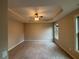 Spacious main bedroom with carpet and a tray ceiling at 5544 Whispering Swan Ct, Douglasville, GA 30135
