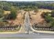 Aerial view of community entrance with paved roads and lush green landscaping at 4540 Natchez Ln, Cumming, GA 30040