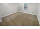 Well-lit bedroom with neutral-toned carpet and window at 1512 Maplewood Ct, Woodstock, GA 30189