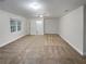 Spacious bonus room with carpet, ceiling fan, and ample natural light at 1512 Maplewood Ct, Woodstock, GA 30189