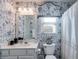 Stylish bathroom with toile wallpaper and white vanity at 8561 Lake Forrest Dr, Douglasville, GA 30134