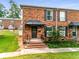 Brick townhouse with a covered entrance and small yard at 5696 Kingsport Dr # 3, Atlanta, GA 30342