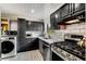 Modern kitchen with dark cabinetry, stainless steel appliances, and white subway tile backsplash at 5696 Kingsport Dr # 3, Atlanta, GA 30342